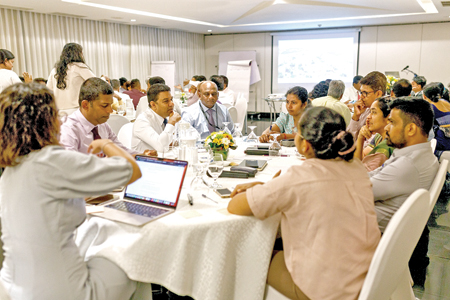 Participants from diverse sectors engaging in a discussion on climate resilience