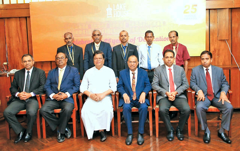 Picture shows long-service award recipients with the Minister and the senior management of the Company. Pictures by Chinthaka Kumarasinghe and Rukmal Gamage