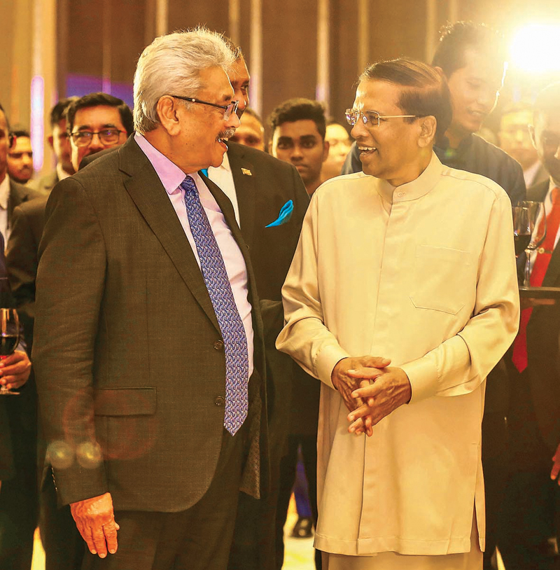 Former Presidents Gotabaya Rajapaksa and Maithripala Sirisenain a friendly conversation 
