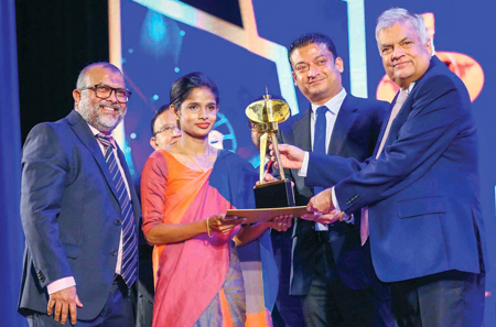 President Ranil Wickremesinghe and State Minister Dilum Amunugama present the Exporter of the Year Award for 2022/23 to CEO,  MAS Kreeda, Ziyan Zahir and Team Member, Sewing at MAS Kreeda, Buddhini Gayanthi. Pic: Sulochana Gamage