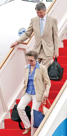 A humble Princess Anne carried her own bags off the plane as she arrived at the Bandaranaike International Airport in Katunayake with her husband Vice Admiral Sir Timothy Laurence