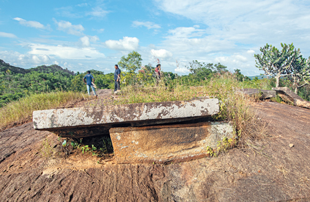 Ruins of buildings, ponds, all made of stones, are scattered in a wide area onthe surface of the rocky boulder