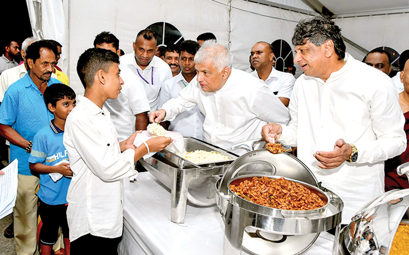 President Ranil Wickremesinghe serves food at the dansala at the Shangri-La Green