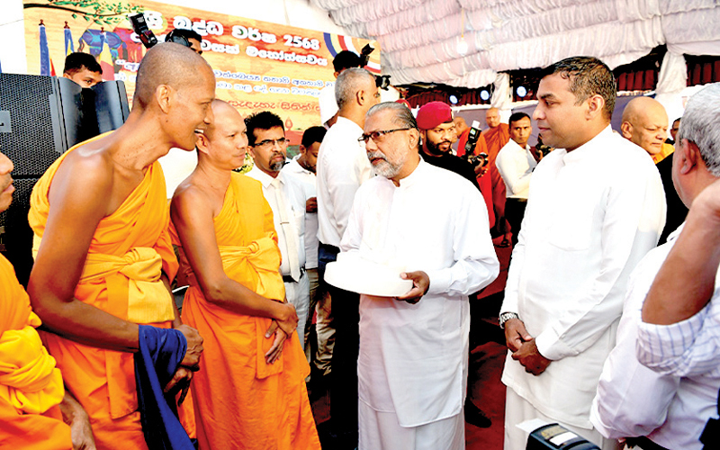 State Ministers Vidura Wickramanayake and Pramitha Bandara Tennakoon in conversation with foreign bhikkhus at the State Vesak ceremony in Matale