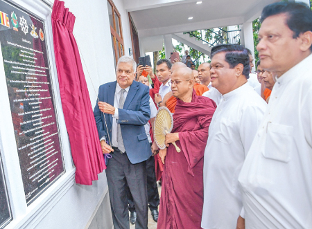 President Wickremesinghe unveils the plaque to mark the opening of the Bhikkhu Centre. Ven. Pitigala Sonuthara Nayaka Thera and Minister Dr. Bandula Gunawardena look on