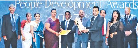 CDB has won three gold awards for three years consecutively at the SLITAD Awards. With Team CDB looking on, Senior Manager Dulanga Gamage and Chief Support Service Officer Nayanthi Kodagoda receive the award and certificate at the ceremony.