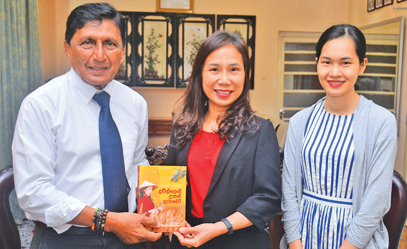 ‘Duvillen Upan Daruwo’, the Sinhala translation of ‘Dust Child’ by famous Vietnamese author, Nguyen Phan Que Mai was presented to the Ambassador of Vietnam to Sri Lanka Trinh Thi Tam by the translator, Rohana Wetthasinghe at the Embassy office, Colombo recently. Third Secretary of the Embassy Toan Nguyen was also present. Picture by Ranjith Asanka