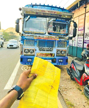 Bus owner poses with fine ticket