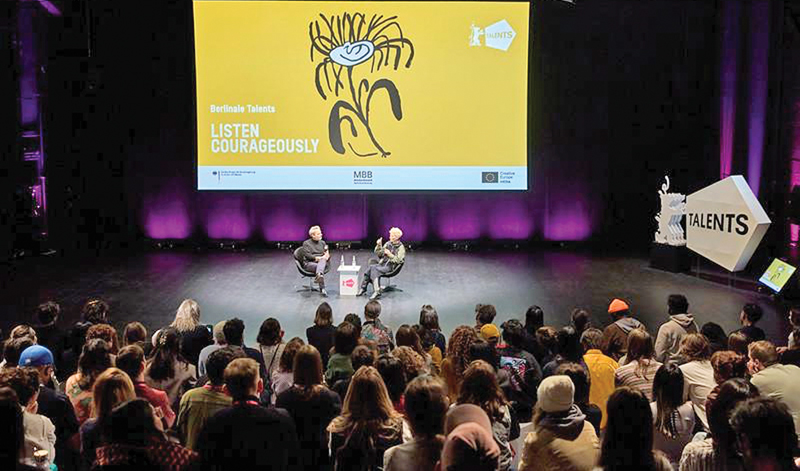 Tobias Pausinger and Tilda Swinton talking at her surprise visit to The 2025 Edition: Take-Off © Jack Hare, Berlinale 2025