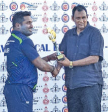 Player of the match Rajiv Nirmalasingham receives his trophy from former Sri Lanka player Vinothan John