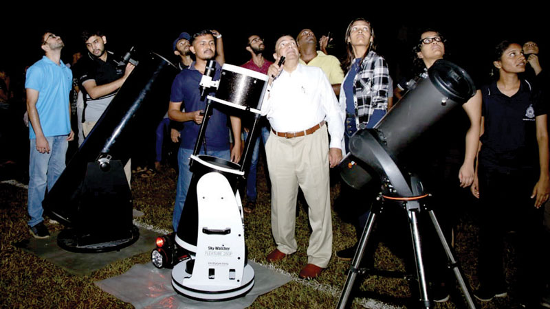 A rare celestial phenomenon of aligning seven planets of the solar system in a row, was visible for Sri Lankans after sunset from February 25 to 28. People witnessed Mercury, Venus, Mars, Jupiter and Saturn without any optical assistance while the other two - Neptune and Uranus - with the help of a telescope. Here the Director of the Astronomy and Space Sciences Unit at the University of Colombo’s Department of Physics, Prof. Chandana Jayaratne and other astronomy enthusiasts observing the planetary alignment, the kind of which will not occur again until 2040, at a camp held in Colombo. Pic by Malan Karunarathne 