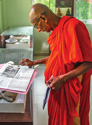 A resident bhikkhu explains about artefacts in the museum